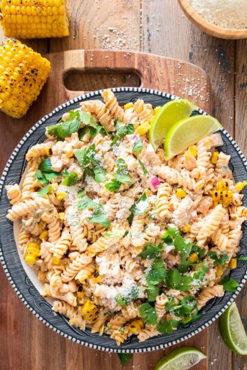 Overhead of mexican street corn pasta salad on a plate with cotija cheese sprinkled around.