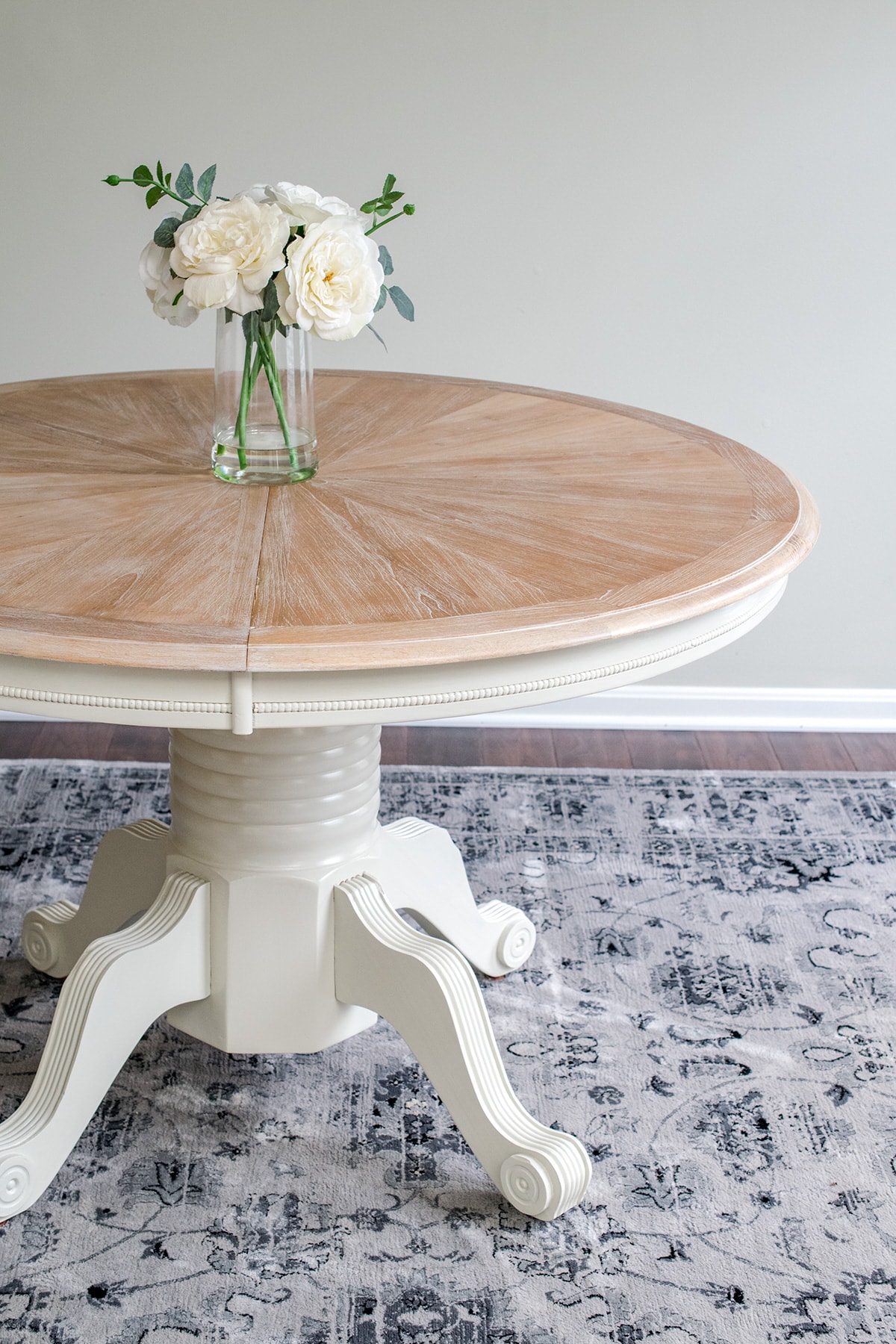 Fusion Mineral Champlain Painted round table with floral centerpiece.