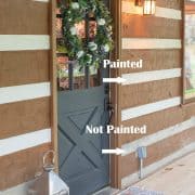 Progress of painted outdoor concrete cement masonry on a rustic log cabin house with a gray door.