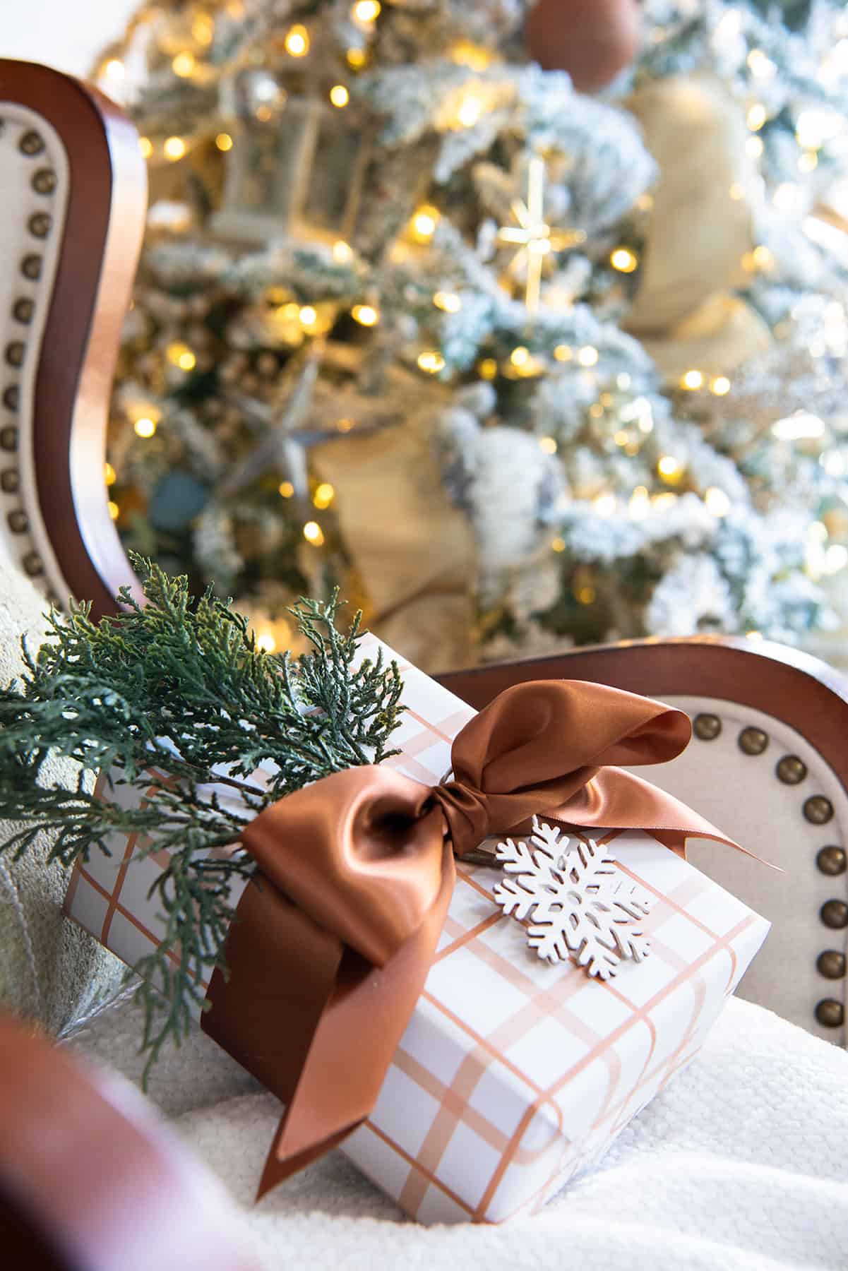 Present on a chair wrapped in natural orange plaid paper and satin ribbon.