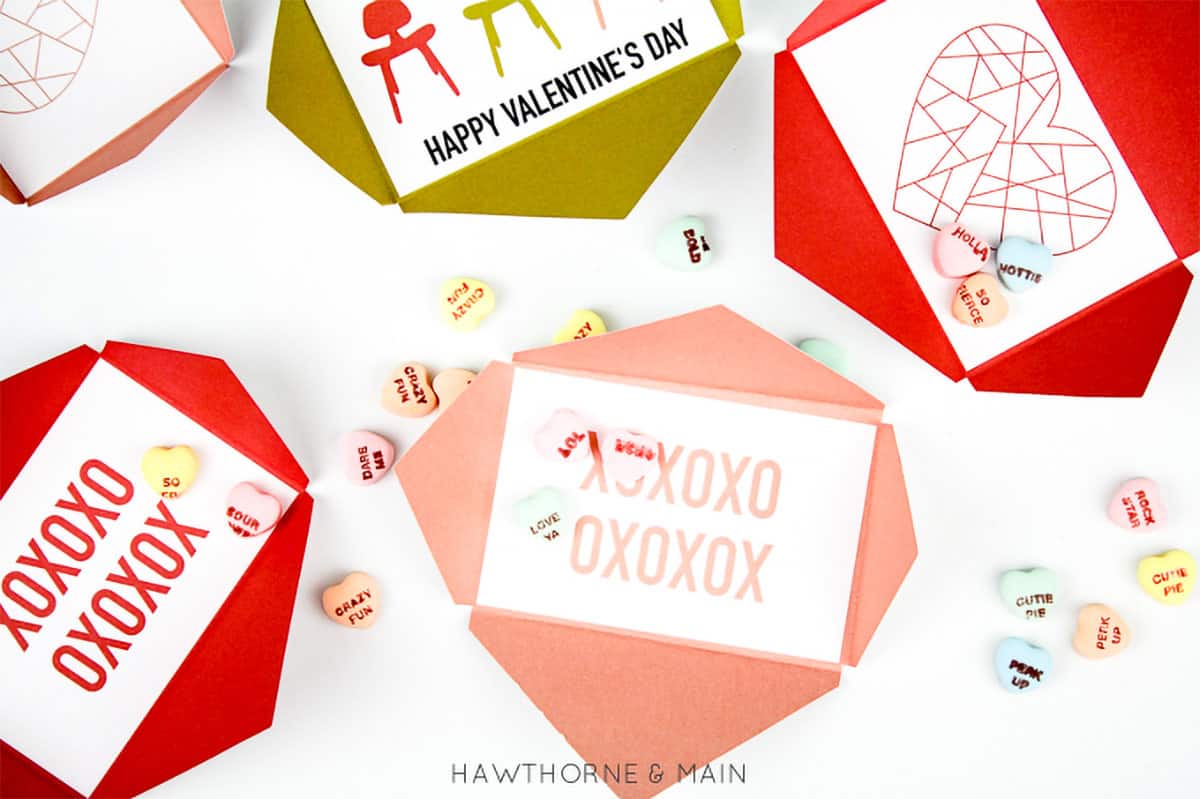 Valentine's Day free printable envelopes in various colors on a table.