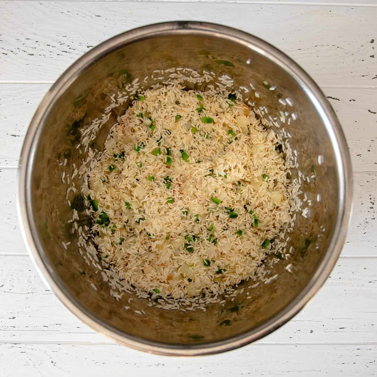 Rice after sauteing in a crockpot rice cooker.