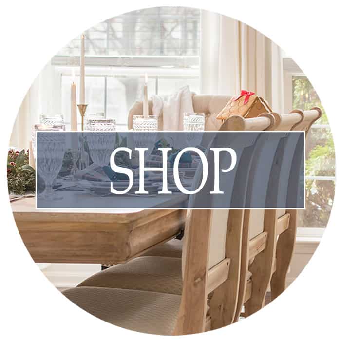 Dining room table with blond chairs and shop title overlay.