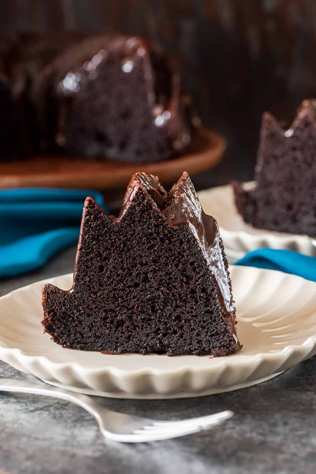 Cross slice of chocolate bundt cake on a plate.