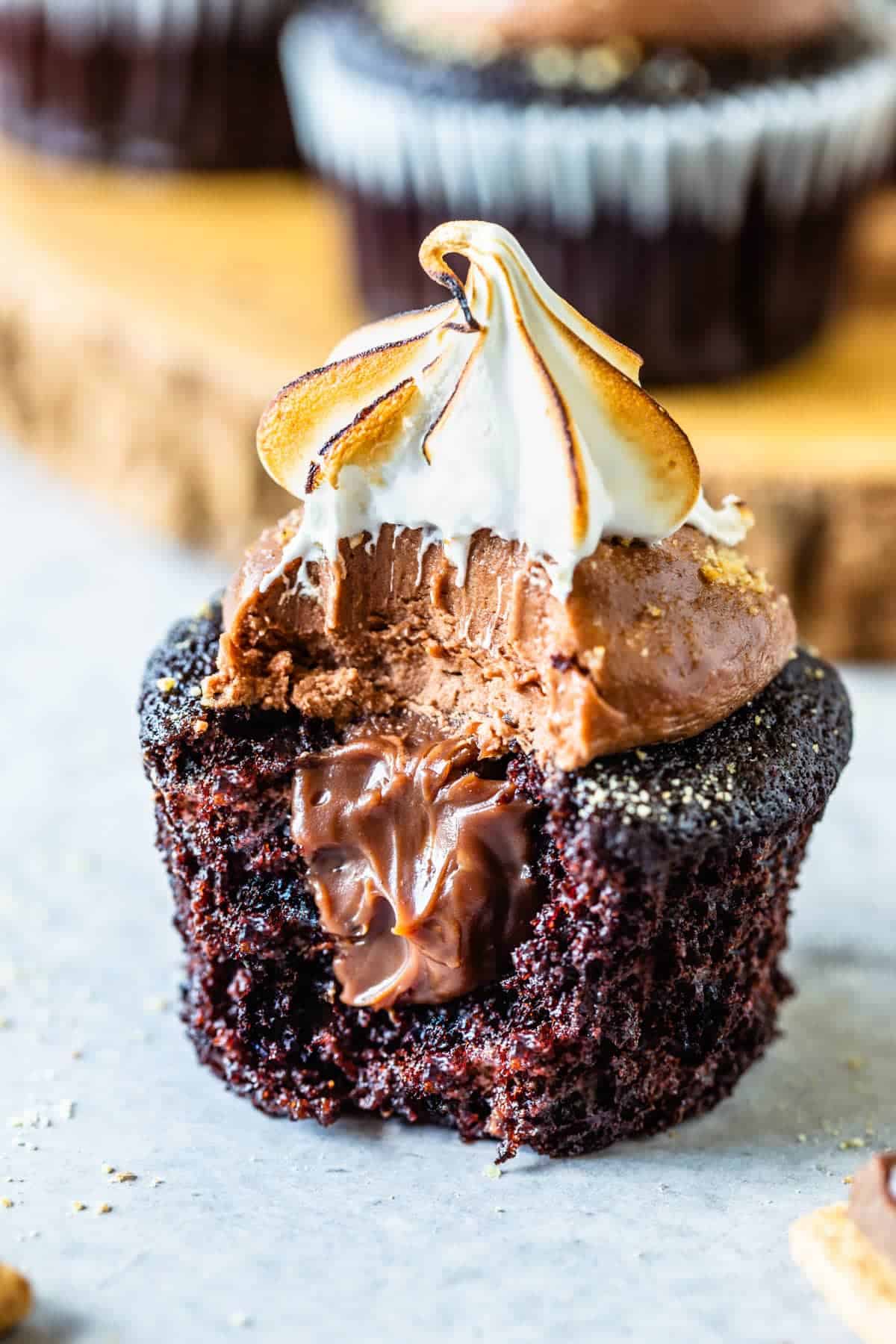 Smores cupcake with exposed center to reveal chocolate filled center, Marshmallow topping.