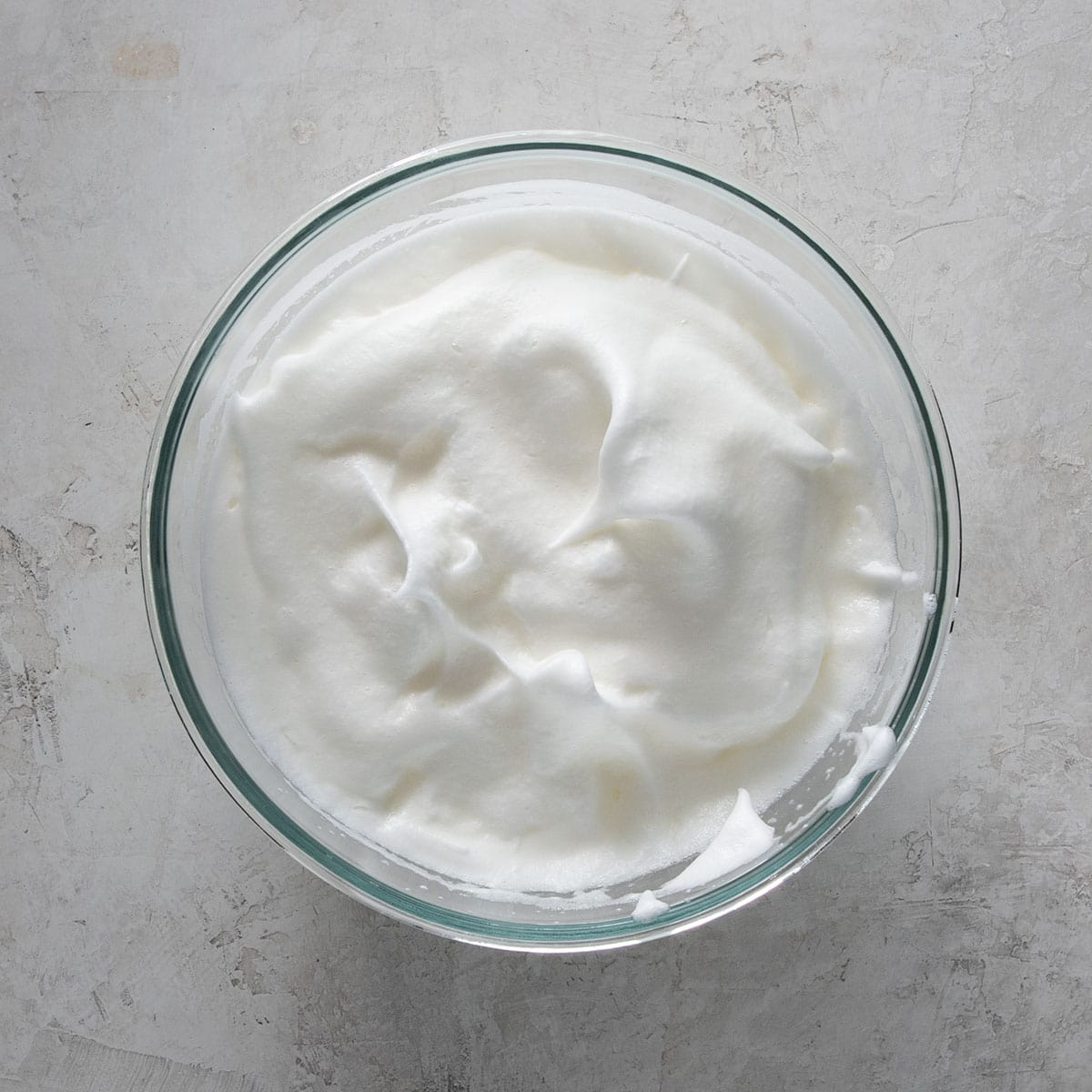 Egg meringue with soft peaks formed to show texture.