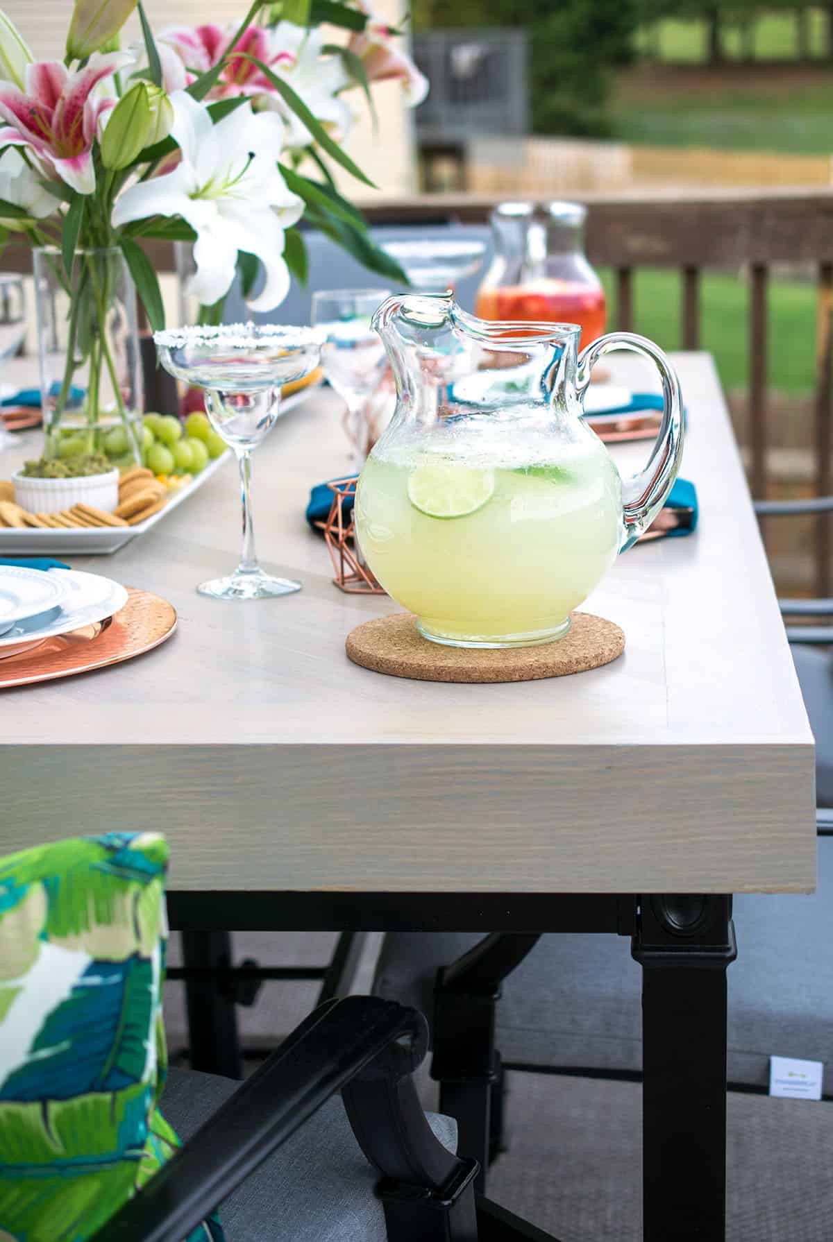 Refinished outdoor patio table and chairs with elegant tropical table settings.