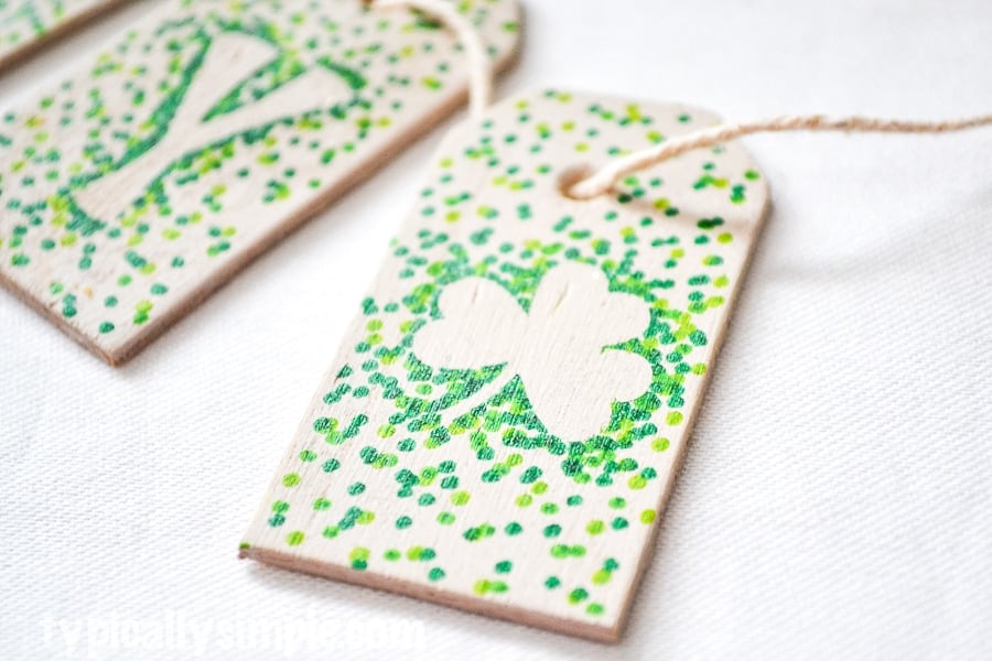 Green polka dotted tags with letters and shamrocks on garland for a banner.