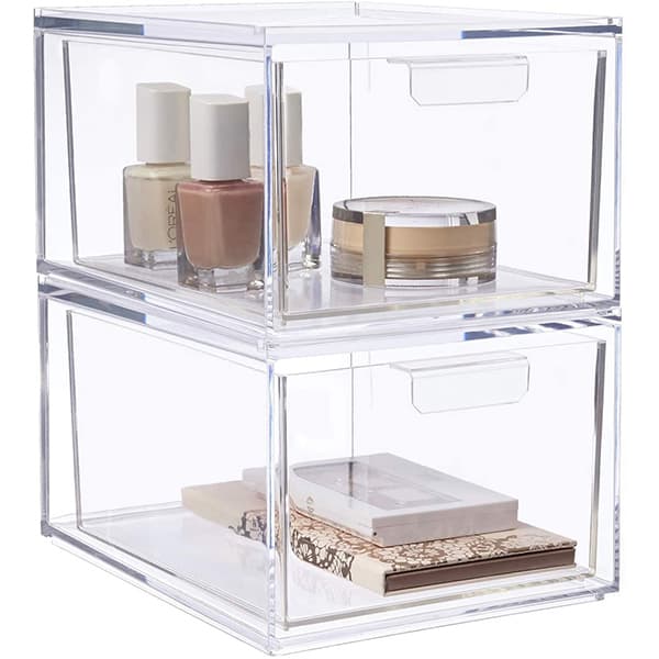Clear plastic stackable drawers with makeup in each drawer.