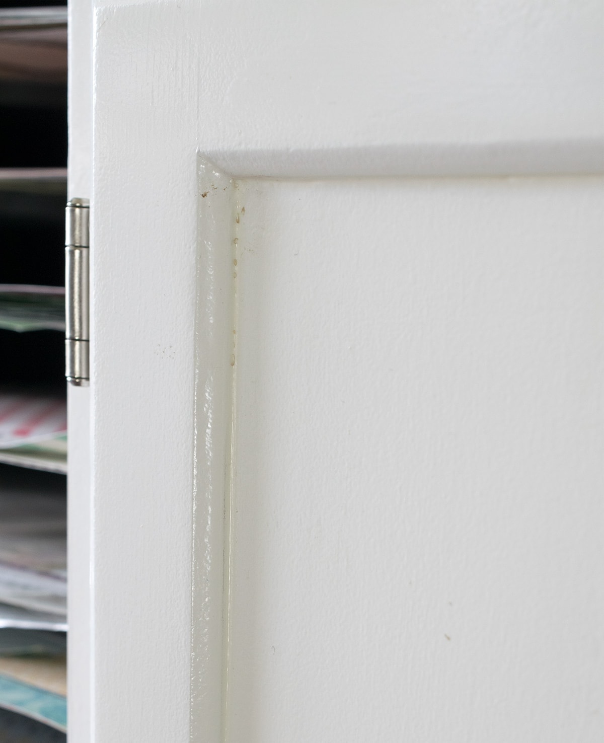 Slight damage on inside corner of white cabinet detail