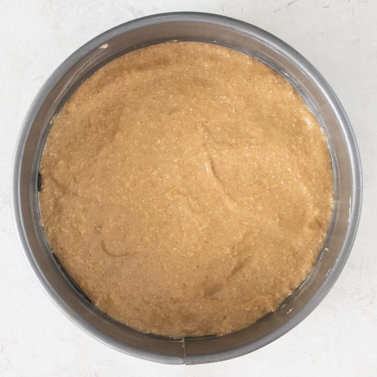 Overhead of cake batter in a springform pan.
