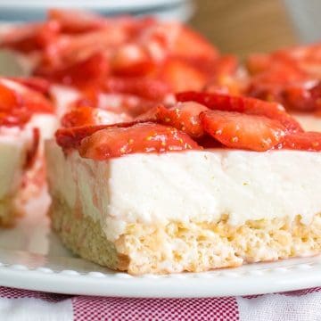 Strawberry cheesecake on top of a rice krispie crust closeup.