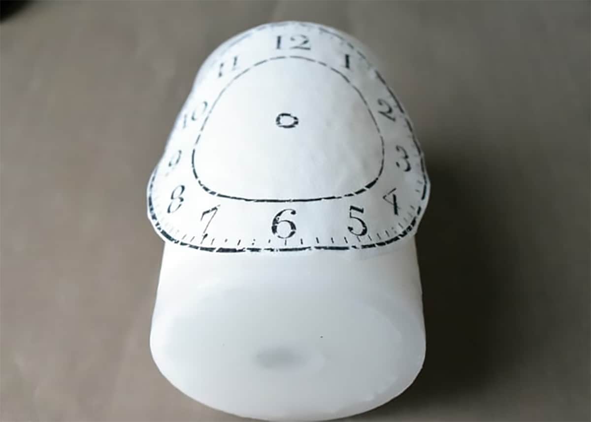 Tissue with stamped image laid over a candle.