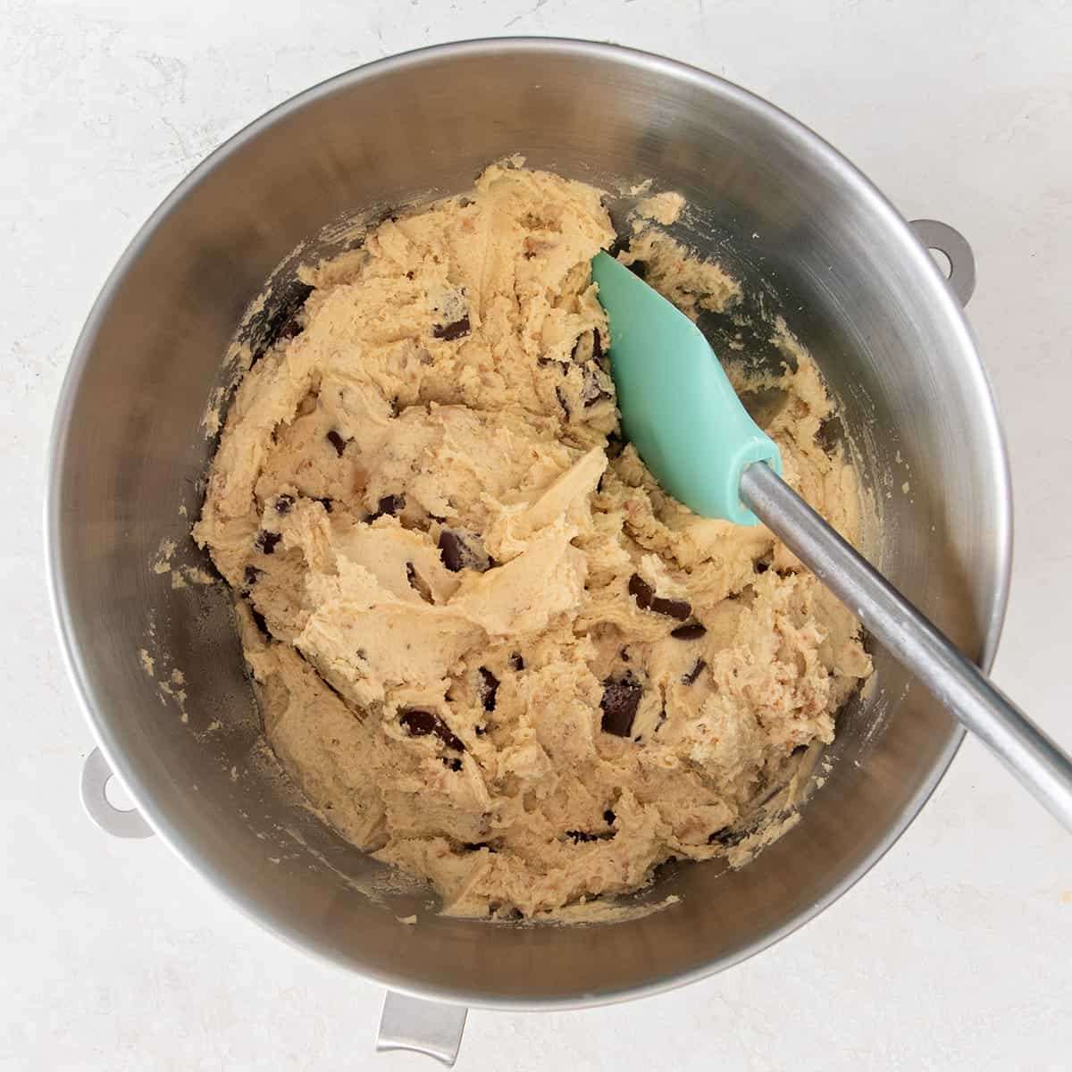 A bowl of cookie dough after stirring in the chocolate chips and toffee bits.