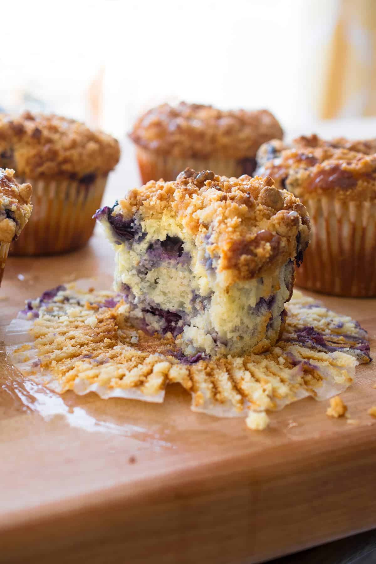 Lemon blueberry muffin with bite missing to show texture inside.