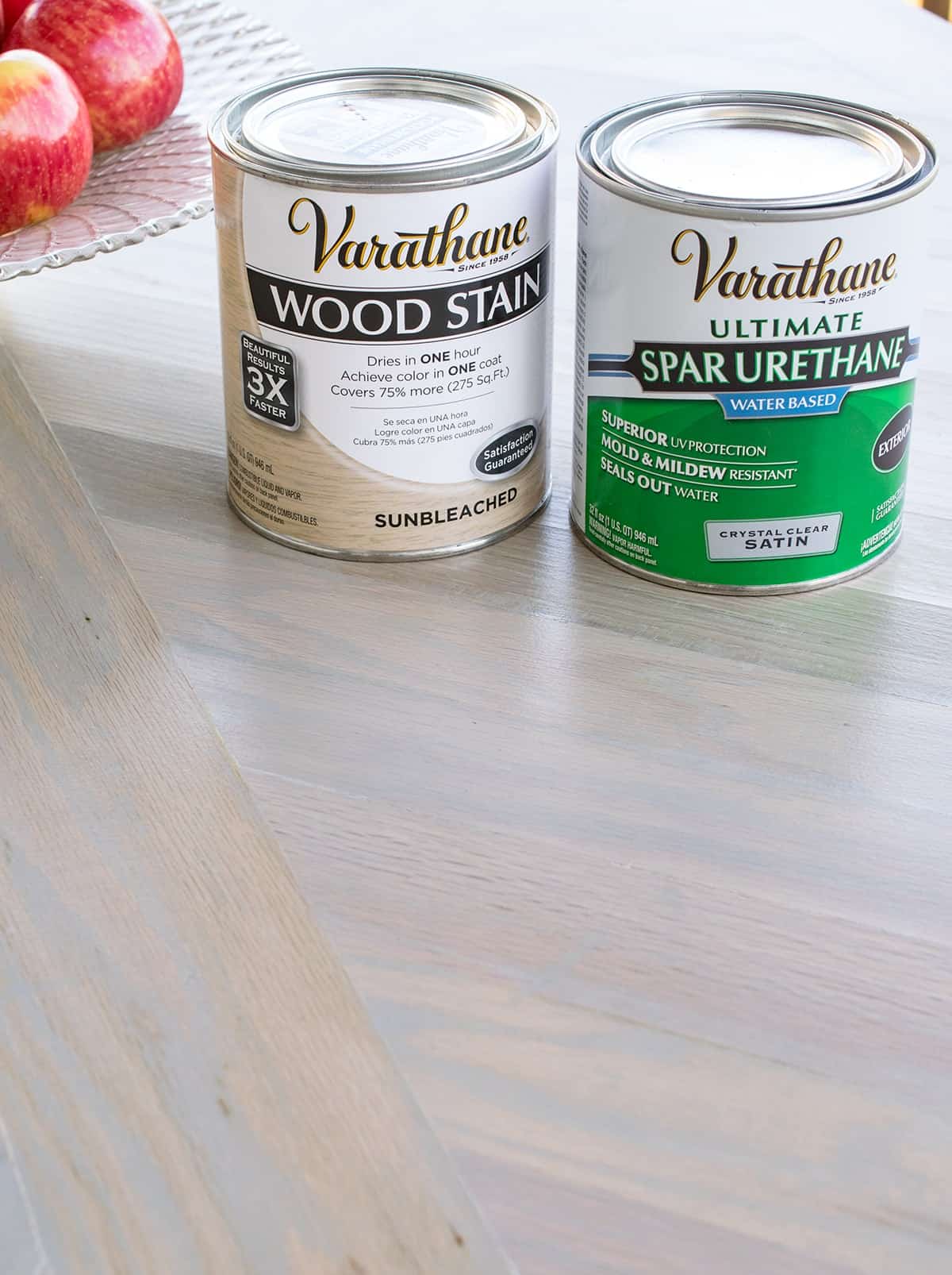 Varathane wood stain and spar urethane wood sealer on tabletop with finished product applied.