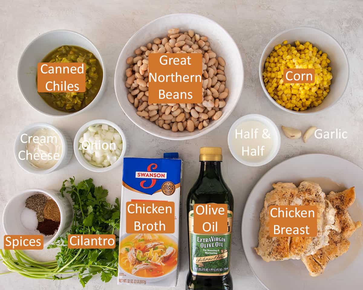 Ingredients for white chicken chili recipe laid out on table with text labels for each.