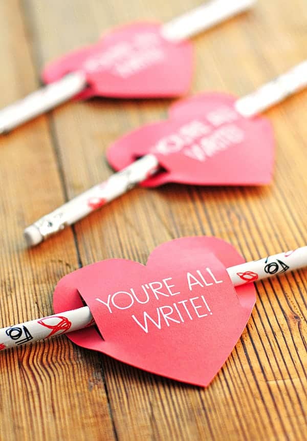Heart shaped pencil holder that says "you're all write" on them.